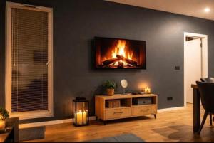 a living room with a fire on the wall at APARTAMENT FLOW Walendów in Walendów