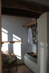 a room with a chair and a dresser in a room at B&B Barba Vigin in San Damiano dʼAsti +40 photos