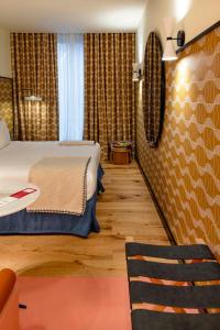 a hotel room with a bed and a chair at Artcore Hotel Porto in Porto