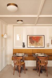 a dining room with two tables and two chairs at Les Sources de Vougeot in Vougeot