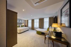a hotel room with a bed and a couch at Aragon House in Bruges