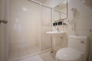 a white bathroom with a toilet and a sink at Tony's house in Jiaoxi +13 photos