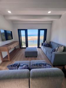 a living room with a couch and a table at Chintsa Oceanfront in Chintsa