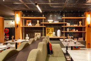 a room with a row of chairs and a table with artifacts at Artcore Hotel Porto in Porto