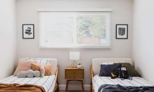 two twin beds in a bedroom with a window at Downings View in Ballynaworthra