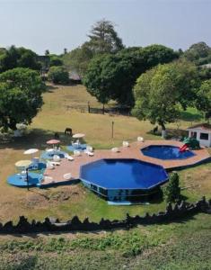 an aerial view of two swimming pools in a field at Pousada Marajoara- Hotel Fazenda-Turismo de Aventura in Soure