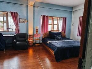 a bedroom with a bed and a chair and a desk at Phafan pool villa in Ban Pa Sang (1) +38 photos