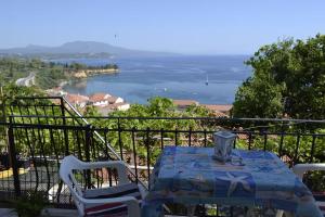 a table and chairs with a view of the water at Panoramic Seaview Apartments - Koroni in Koroni +9 photos
