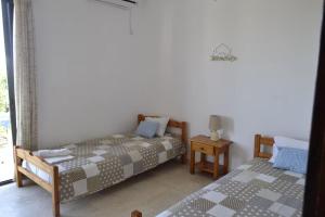 a bedroom with two beds and a window at Panoramic Seaview Apartments - Koroni in Koroni