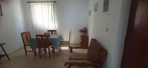 a dining room with a table and chairs and a window at Panoramic Seaview Apartments - Koroni in Koroni
