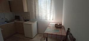 a small kitchen with a small table and a window at Panoramic Seaview Apartments - Koroni in Koroni