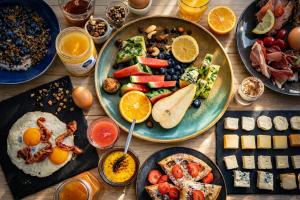 a table topped with plates of food and drinks at Hôtel L'Amandier in Libramont +85 photos
