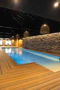 a swimming pool with blue water in a building at Ayres de Calafate in El Calafate