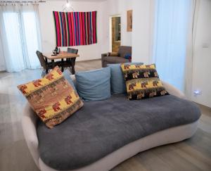 a couch with pillows on it in a living room at Borgo Dei Cedri in Bari