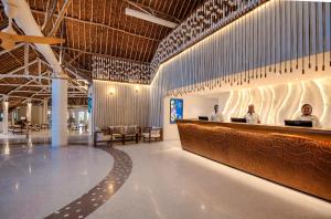 two men sitting at a bar in a building at Diamonds Leisure Beach & Golf Resort in Diani Beach