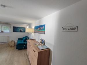 a living room with a blue couch and a table at FeWo Heimathafen in Bodman-Ludwigshafen +25 photos