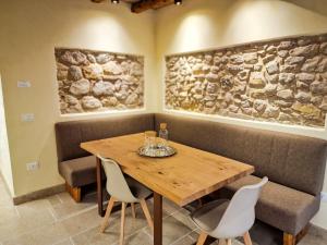 a dining room with a wooden table and chairs at Sotto la Torre in Marostica +15 photos