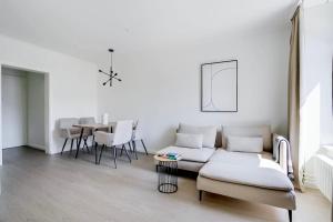 a living room with a couch and a table at Oak Suite · District 4 in Zurich