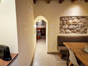 a dining room with a table and a stone wall at Sotto la Torre in Marostica