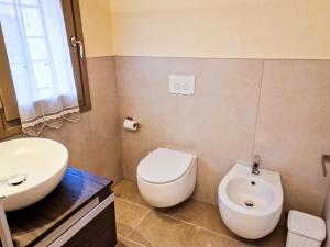 a bathroom with a white toilet and a sink at Sotto la Torre in Marostica