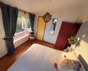 a bedroom with a large bed and a window at Refugio Urbano Melipulli in Puerto Montt +11 photos