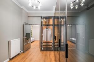 a dressing room with a mannequin in a glass case at ICONIC LEGACY Suite seafront in Thessaloniki +18 photos