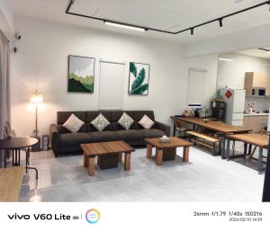 a living room with a couch and tables at Fu Qiaoqing Travel電梯獨棟 in Wujie