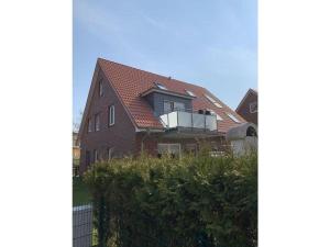 a house with a balcony on the side of it at grosser-Fiete in Wittdün +12 photos