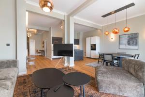 a living room with a couch and a table at ICONIC LEGACY Suite seafront in Thessaloniki