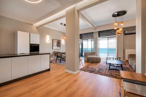 an open living room with a kitchen and a living room at ICONIC LEGACY Suite seafront in Thessaloniki