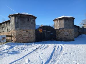 two towers in the snow with footprints in the snow at Domaine de la Ferté Clairbois in Sainte-Suzanne