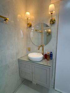 a bathroom with a sink and a mirror at Pontal Beach Loft I in Rio de Janeiro +29 photos