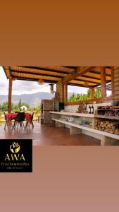 a patio with a table and chairs and a table at AWA ECO GlAMPING SPA in Villa de Leyva