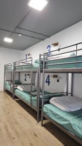 a room with three bunk beds in a room at Bilbao Metropolitan Hostel by Bossh! Hotels in Bilbao