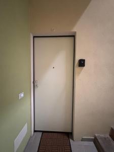 a white door in a room with a wall at Carlotta 5 in Biella +1 photo
