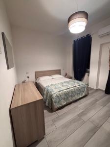 a bedroom with a bed and a wooden table at Carlotta 5 in Biella