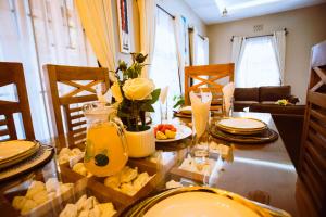 a dining room table with food on it at Tunji Homestay in Arusha