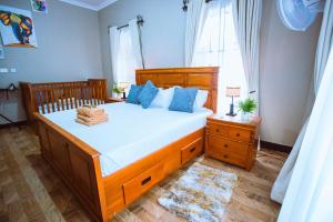 a bedroom with a large bed and a window at Tunji Homestay in Arusha