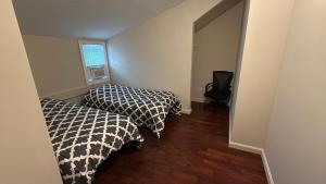 a room with two beds and a window at Esjacpe Guest House 2 in Boston