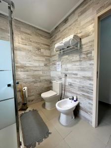 a bathroom with a toilet and a sink at Green Sunrise House in Nordeste +68 photos