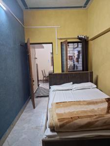 a bedroom with a bed in a room with a mirror at Privyrooms Raptinagar in Gorakhpur