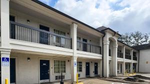 an apartment building with a balcony on the second floor at Studio 6-Houston, TX - Hobby South in Houston