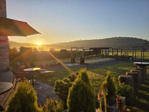 a garden with a sunset in the background at Q-time Barvaux, Durbuy-Adults Only in Durbuy