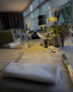 a table with two wine glasses and a napkin at Logis - Hôtel du Nord et Restaurant La Table d'Elisa in Compiègne +25 photos
