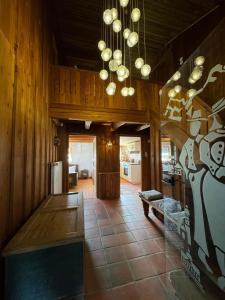 a living room with wooden walls and a chandelier at Haus Bergsteigerglück in Schleching