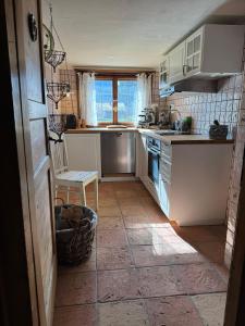 a kitchen with a sink and a stove top oven at Haus Bergsteigerglück in Schleching +13 photos