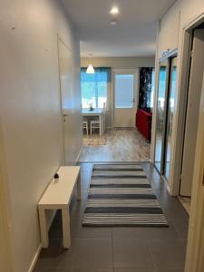 a hallway with a table and a rug on the floor at Apartment Annalantie in Pyhäjoki
