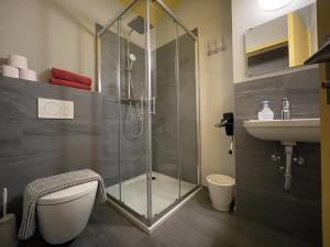 a bathroom with a shower and a toilet and a sink at Pardo Bar in Locarno +50 photos
