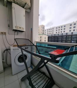 a balcony with a washing machine and a table at Perle studio lac 2 tunisia mall in Tunis