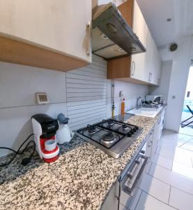 a kitchen with a stove and a counter top at Perle studio lac 2 tunisia mall in Tunis